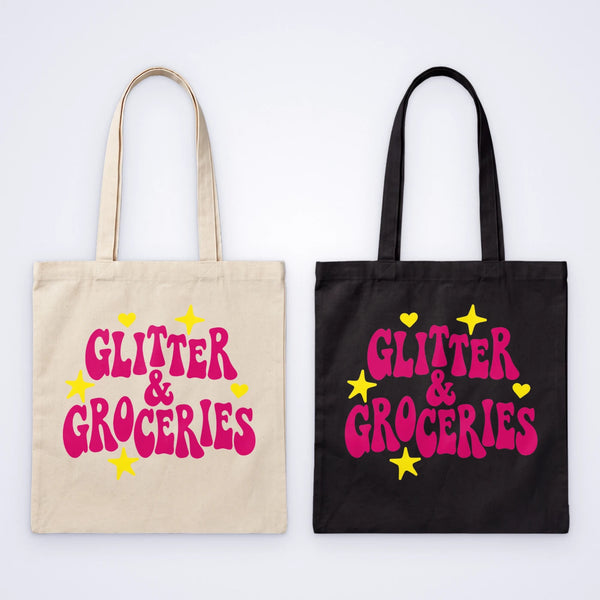 Natural and black cotton custom tote bags screen printed in pink and yellow with the words Glitter & Groceries