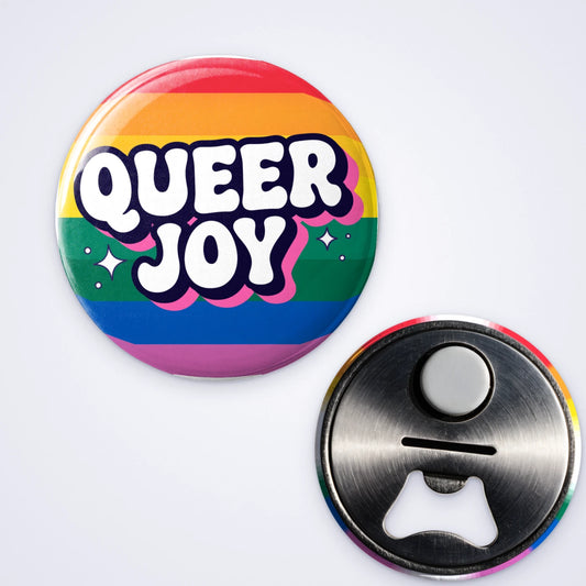 One custom bottle opener magnet printed with Queer Joy on rainbow stripes, shown with the bottle opener back