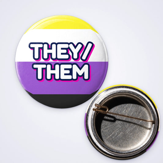 One custom 25mm D-pin badge reading they/them on non-binary pride stripes, shown with the D-pin back